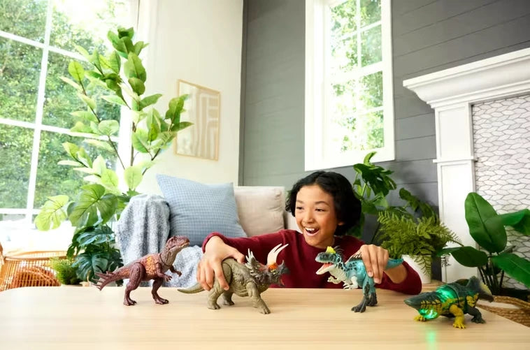 Child playing with Jurassic World Wild Roar Cryolophosaurus and other dinosaur toys