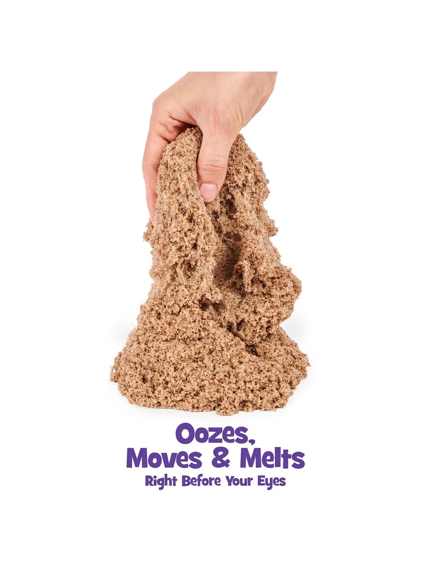 Hand squeezing soft brown Kinetic Sand showing oozing texture – Ireland