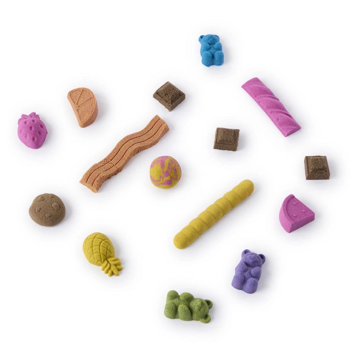 Assorted colourful Kinetic Sand shapes arranged on a white background