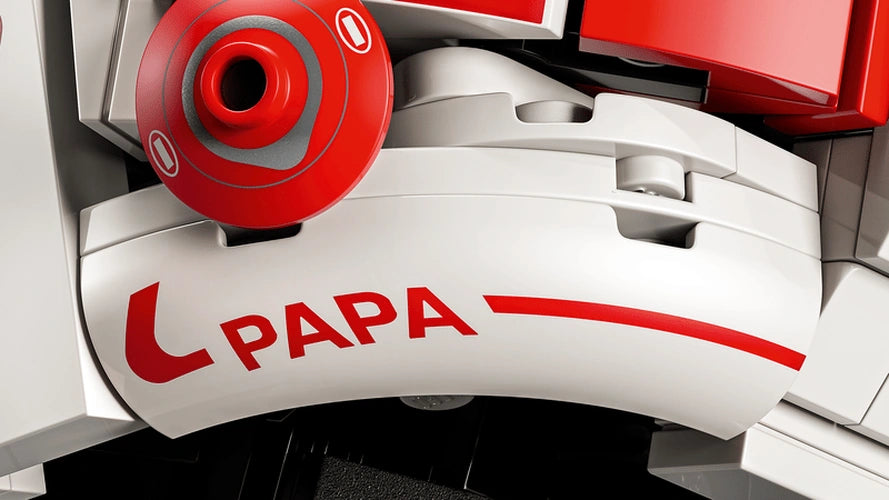 Close-up of the LEGO Charles Leclerc Ferrari helmet showing the red Papa lettering on a white curved panel beside a circular red helmet fitting.