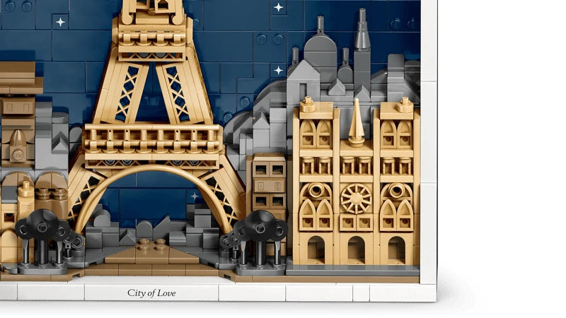 Close view of the lower Eiffel Tower and Notre-Dame de Paris against the dark blue skyline in the LEGO Architecture model