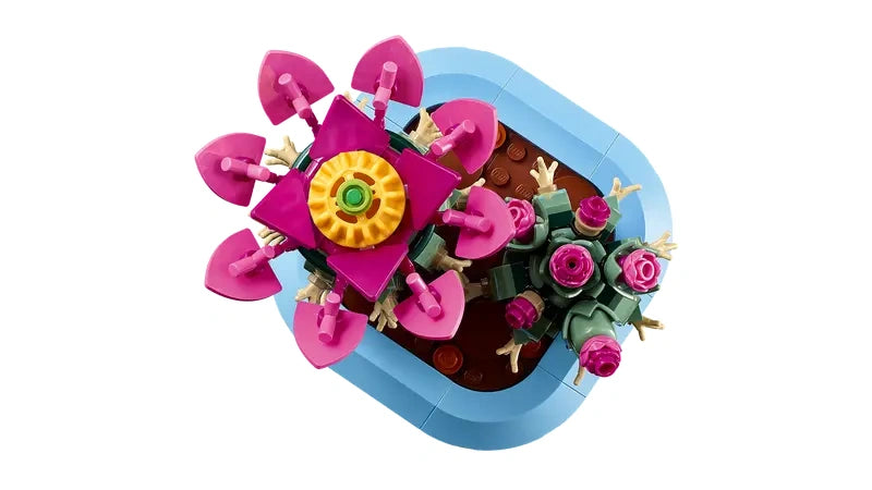 Top view of LEGO cactus models in a light blue plant pot showing a large pink flower and smaller pink buds
