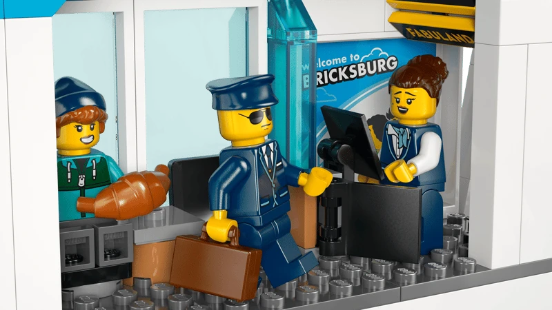 LEGO City airport check-in counter with airline staff minifigure, pilot minifigure and passenger luggage