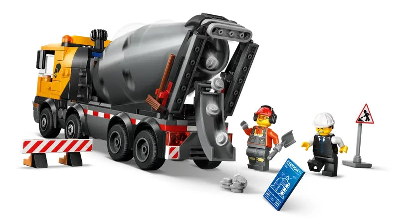 Rear view of the LEGO City cement mixer truck with drum and chute visible, alongside three construction minifigures and accessories