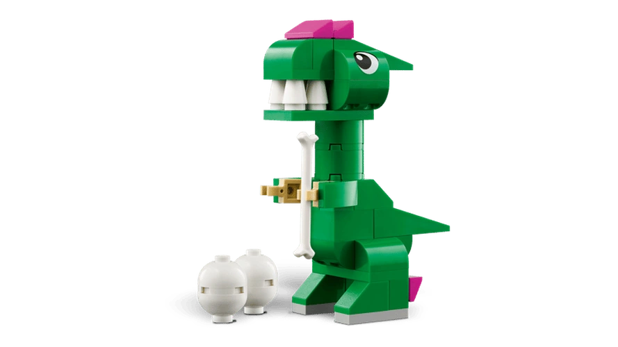 Green LEGO Classic Creative Dinosaurs T. rex model with white teeth, pink head details, short arms and a white dinosaur egg