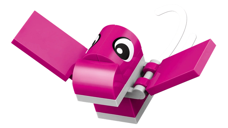 Close-up of pink flying dinosaur from LEGO Classic Creative Dinosaurs 11041 with outstretched wings, large eyes and white curved details