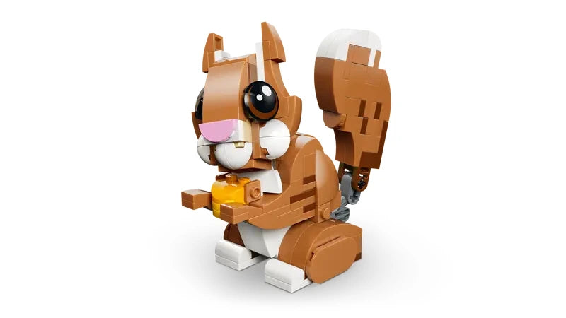 LEGO Creator squirrel model holding a yellow acorn with raised tail