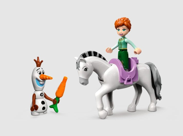 Anna riding horse Kjekk while Olaf offers a carrot in LEGO play scene