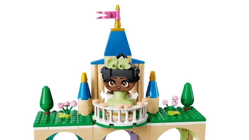 Close up view of the top tower of the LEGO Disney Princess castle with balcony, flags and Mini Tiana figure visible