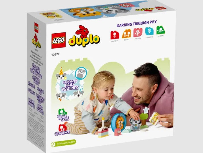 Child playing with LEGO DUPLO 10977 puppy and kitten with a parent