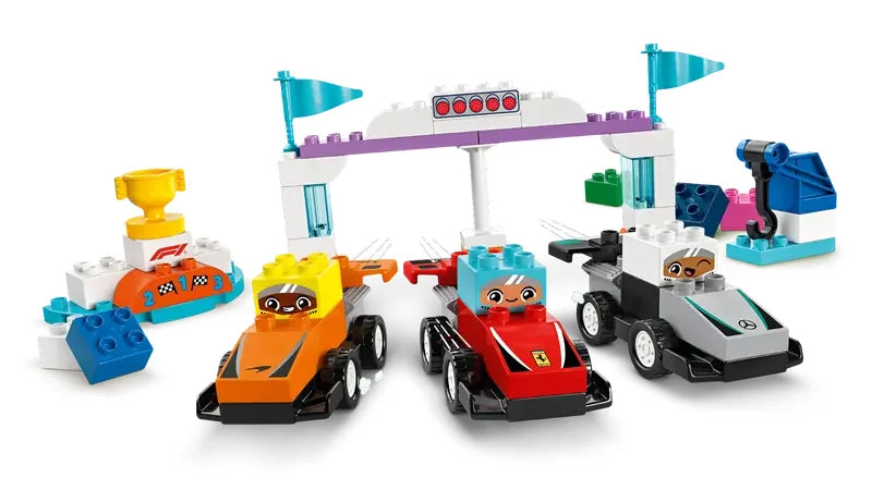 LEGO DUPLO F1 Team Race Cars and Drivers playset showing race track arch, cars, podium and trophy build