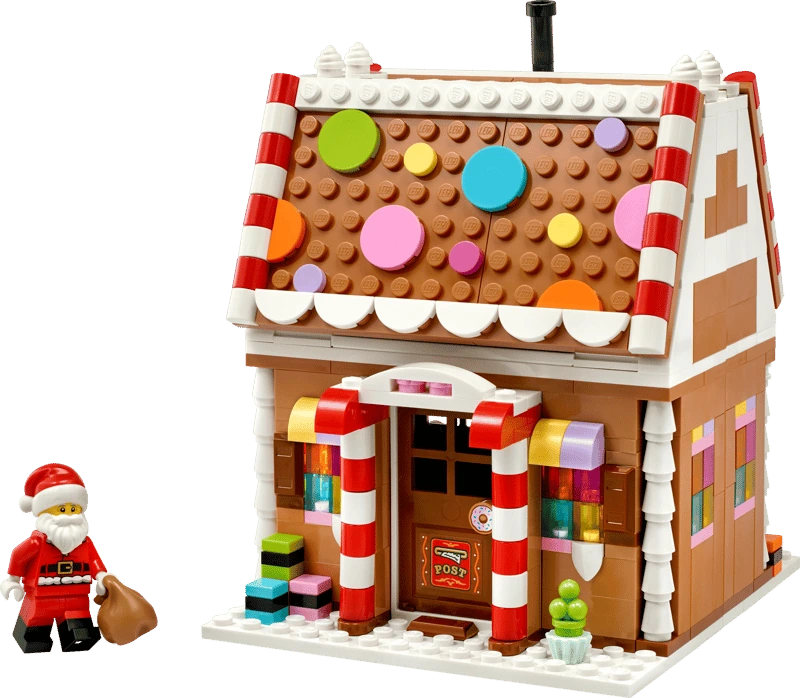 LEGO Festive Gingerbread House 40809 with Santa minifigure and brown sack beside the front entrance