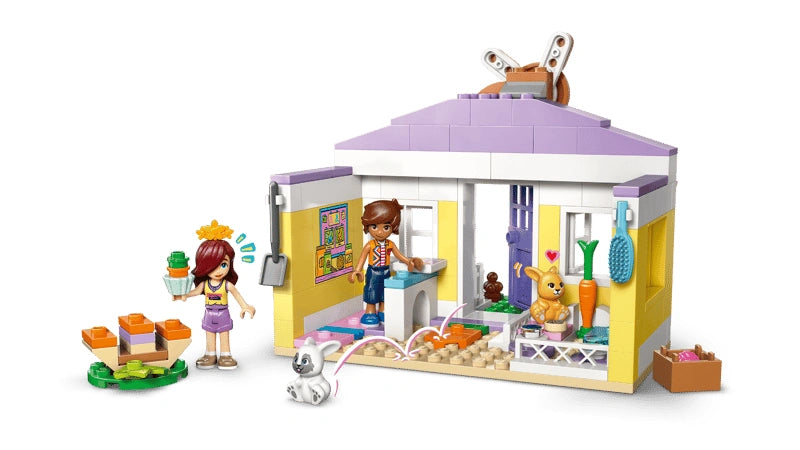 LEGO Friends Heartlake City Bunny Hotel 42679 bunny hotel shown open with Paisley and Leo minidolls and two bunny figures positioned around the hotel