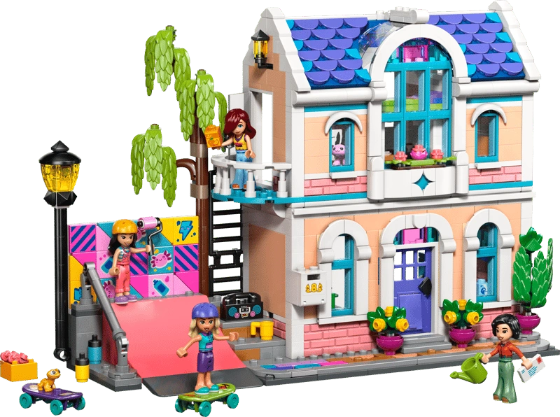 LEGO Friends Liann's Family House 42687 showing the two storey house with purple tiled roof, balcony, colourful skate ramp, tree, minidolls and outdoor accessories.