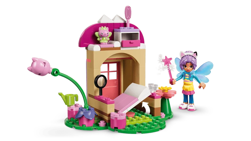 Open LEGO Gabby's Dollhouse Kitty Fairy's Garden House 11212 showing the interior, bed, Gabby and Kitty Fairy