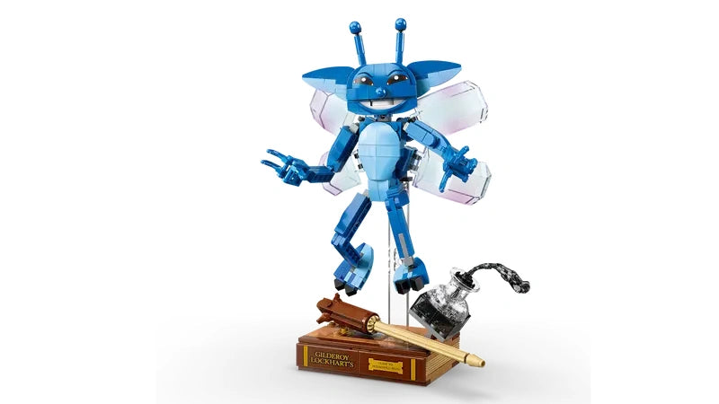 Assembled LEGO Cornish Pixie figure posed in a flying position on a transparent display stand with wings spread and ink bottle accessory visible