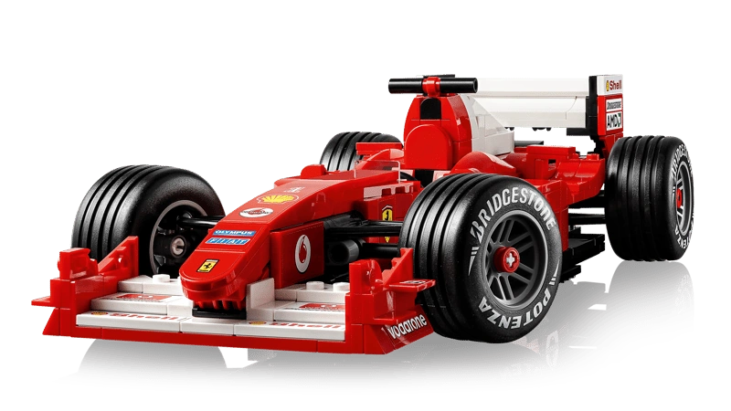LEGO Icons Ferrari F2004 completed model close-up showing red bodywork, Bridgestone Potenza tyres and white rear wing