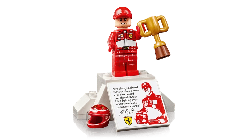 LEGO Icons Michael Schumacher minifigure in red racing suit holding trophy on podium display stand with printed quote