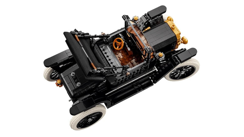 Overhead view of the LEGO Icons Ford Model T showing the brown floor, orange steering wheel, black seating, split windscreen and four white tyres