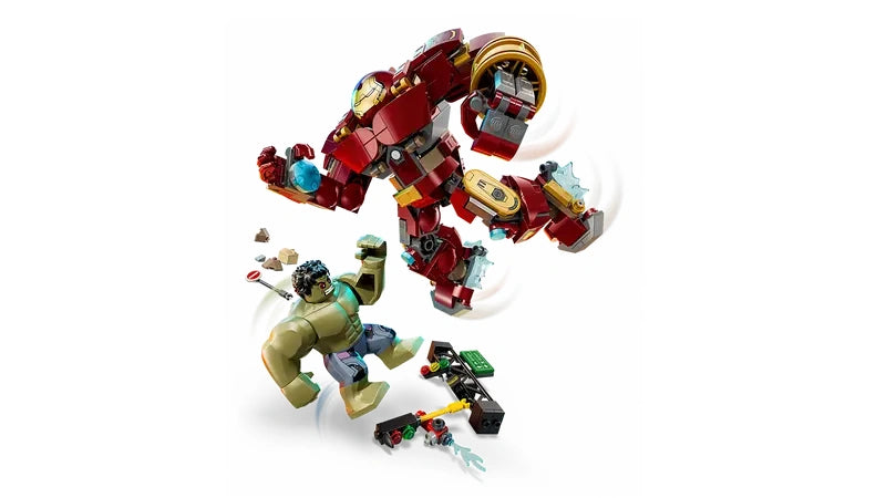LEGO Hulkbuster mech leaping above The Hulk figure with street debris, traffic light accessory with battle movement motion effects on both figures.