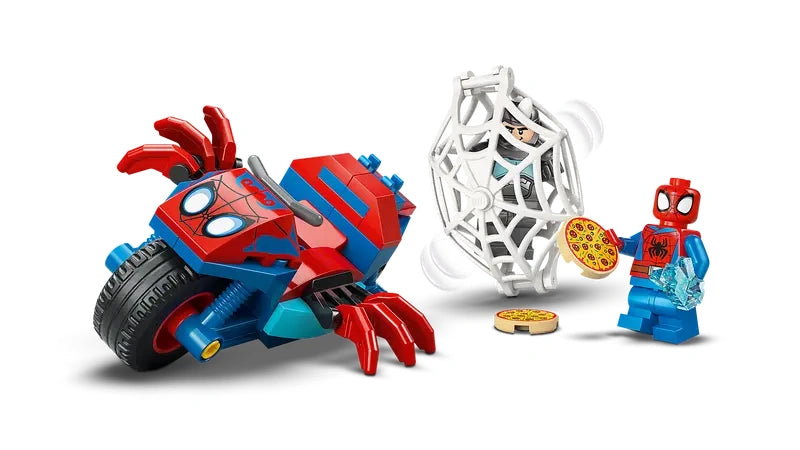 LEGO spider shaped red and blue motorcycle beside a white web trap holding the Rhino minifigure, with Spidey minifigure holding a pizza tile and a blue crystal element, plus a pizza tile on the ground on a white background