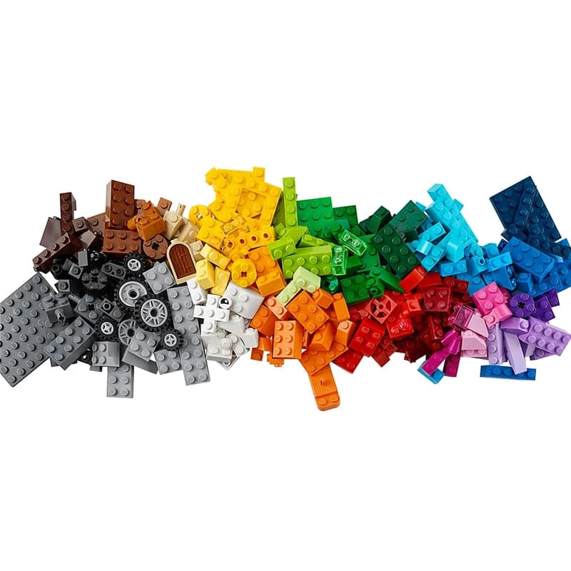 LEGO Medium Creative Brick Box 10696 collection of colourful LEGO bricks, plates and wheels arranged by colour on a white background.