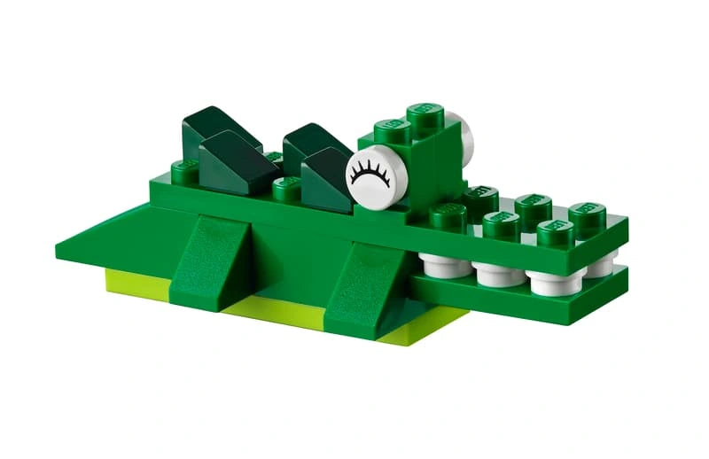 LEGO Medium Creative Brick Box 10696 green crocodile model with white teeth, round eyes and a long brick built body.