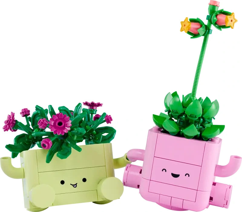 Two LEGO plant models in smiling green and pink pots angled together