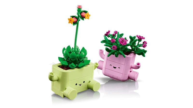 Two LEGO plant models in smiling green and pink pots shown from the front