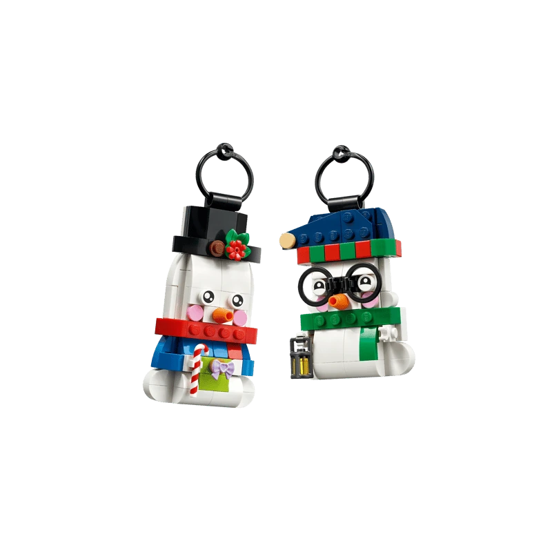 Two LEGO snowman ornaments with black hanging loops, one wearing glasses and a blue hat and one in a black top hat