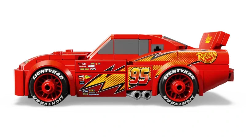 Side profile of LEGO Speed Champions Lightning McQueen model car showing red body, lightning bolt graphic, number 95 and printed wheels