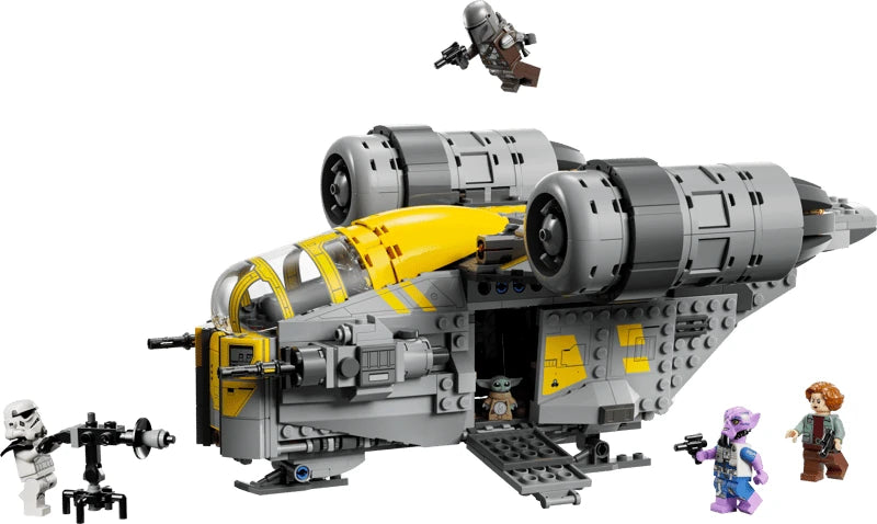 Completed LEGO Star Wars The Razor Crest with an open side ramp, The Mandalorian above the ship, Grogu inside and three minifigures beside an E-Web blaster