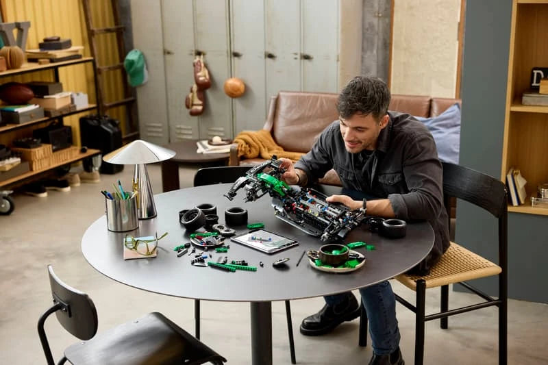 Person building LEGO Technic Aston Martin Aramco AMR25 F1 Car