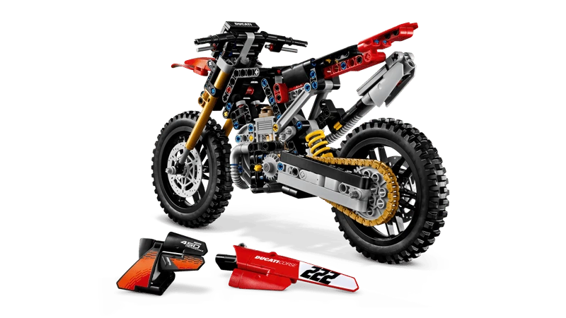 LEGO Technic Ducati Desmo450 MX Factory Motorcycle 42238 with the seat and red body panels removed and placed in front
