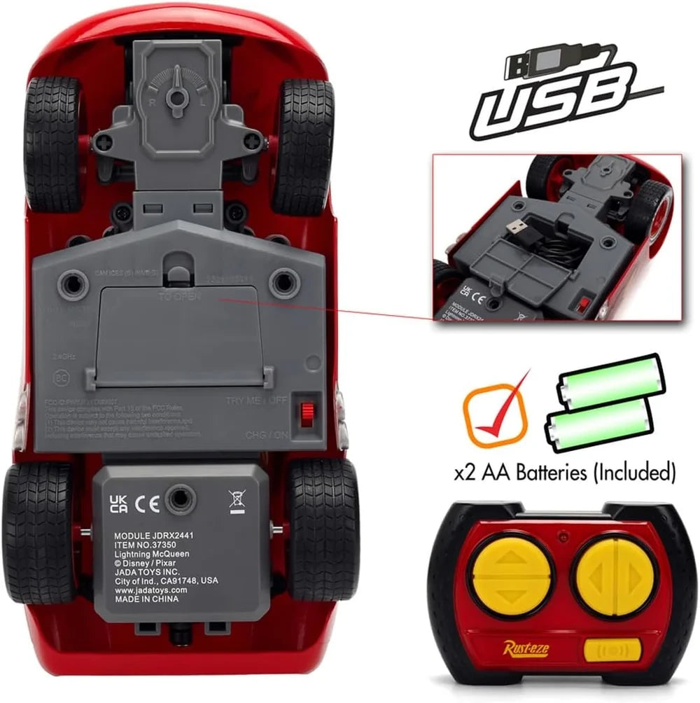 Lightning McQueen Animated RC underside showing the battery compartment, USB charging cable storage and power switch, alongside the remote controller and two included AA batteries.