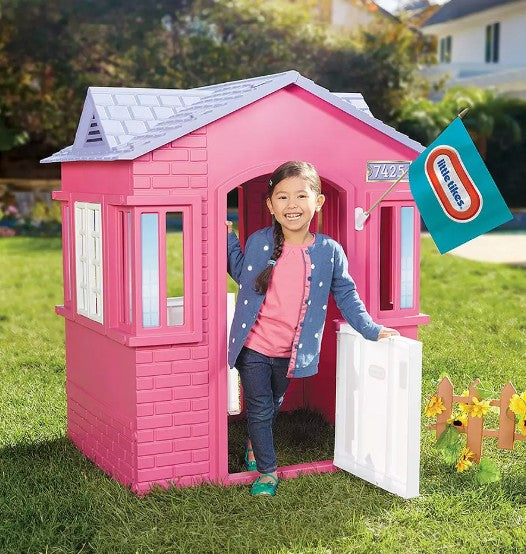 Girl stepping out of Little Tikes Cape Cottage Pink Playhouse - ToyTown.ie Ireland