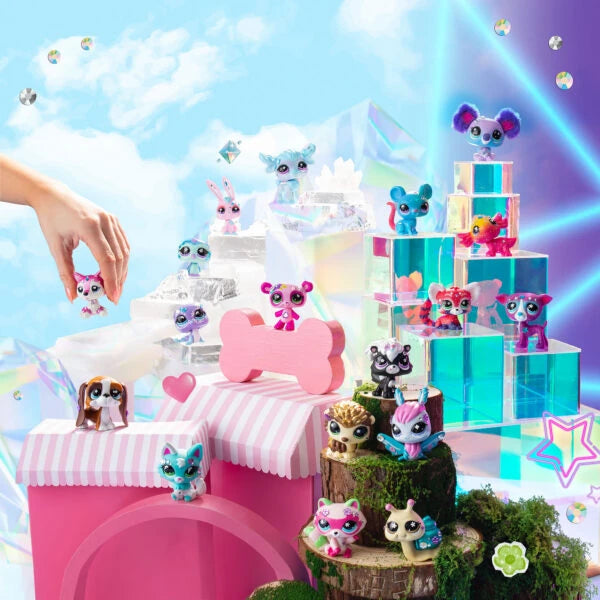 Colourful Littlest Pet Shop animal figures arranged on transparent display blocks, pink striped platforms and miniature green scenery.