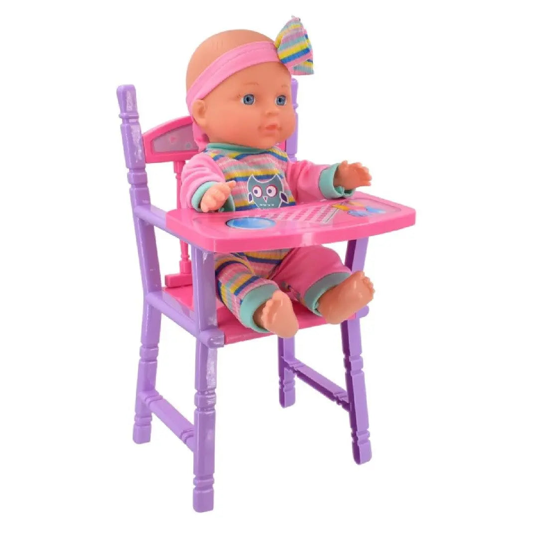 Lullaby Baby doll wearing a striped owl-print romper and pink headband with bow, seated in a purple toy high chair with pink tray