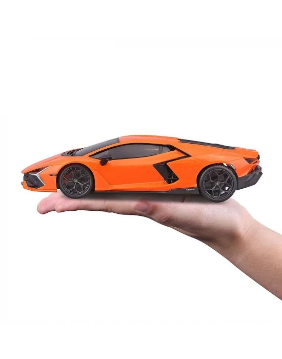 Side view of the orange Lamborghini Revuelto 1:24 RC car resting on an open hand, showing the black wheels, low roofline, angular side air intake and rear bodywork.