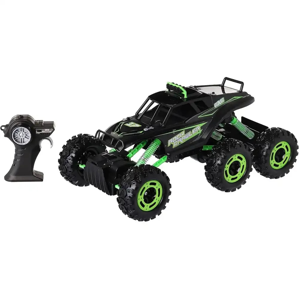 Black body, neon-green rims and coils on the Maisto Rock Crawler 6x6 beside its black pistol-grip remote on white in Ireland