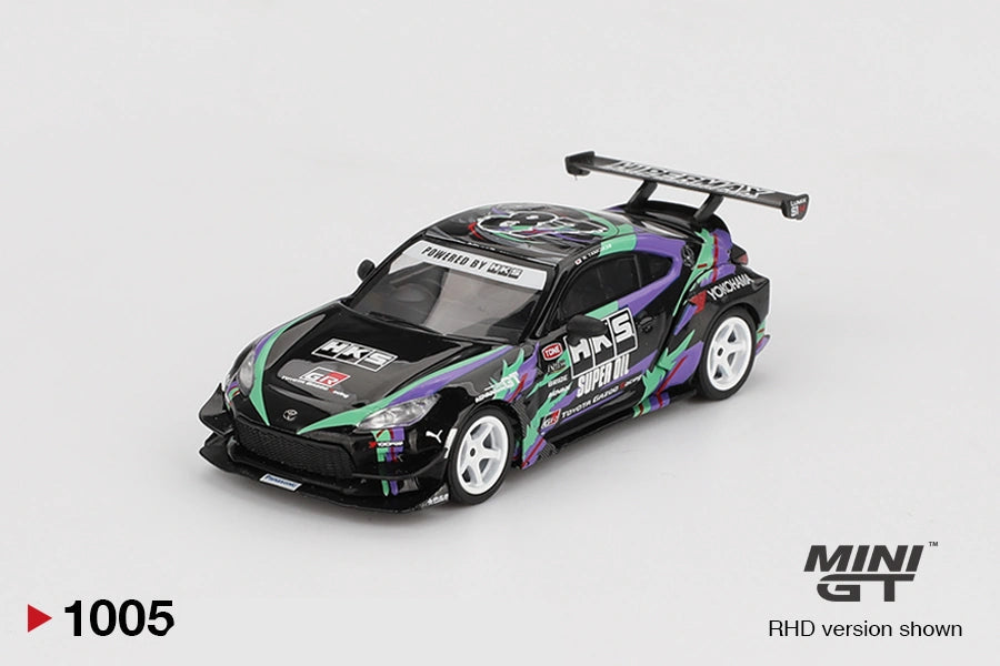 Mini GT Toyota GR86 HKS Type R front three quarter view showing the black bonnet with HKS branding, purple and green graphics, white wheels, front splitter and large rear wing