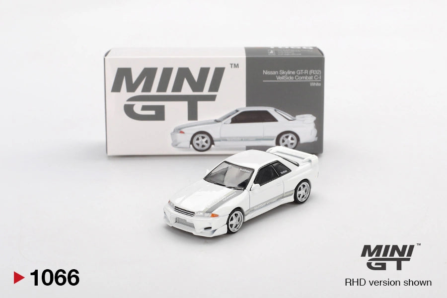 Mini GT Nissan Skyline GT-R R32 VeilSide Combat C-I White diecast car shown from the front three quarter angle, with silver wheels, grey side graphics and its illustrated Mini GT collector box