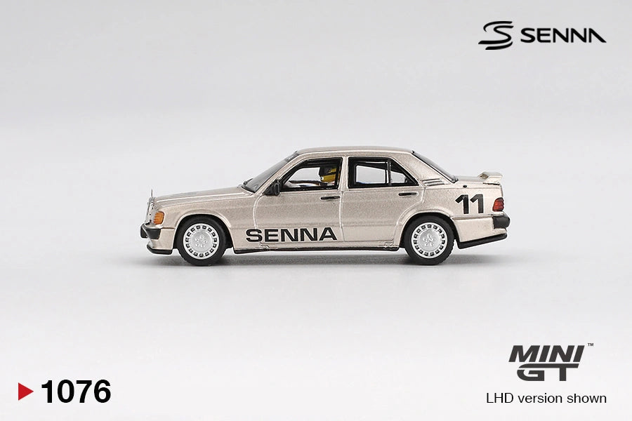 Side profile of Mini GT Mercedes-Benz 190 E 2.3-16 No.11 Ayrton Senna showing metallic gold bodywork, large SENNA door lettering, number 11 rear markings, silver wheels and rear spoiler