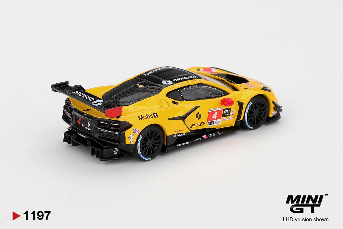 Rear three quarter view of Mini GT Chevrolet Corvette Z06 GT3.R No.4 showing the black rear diffuser, large rear wing, yellow bodywork, racing decals and black wheels
