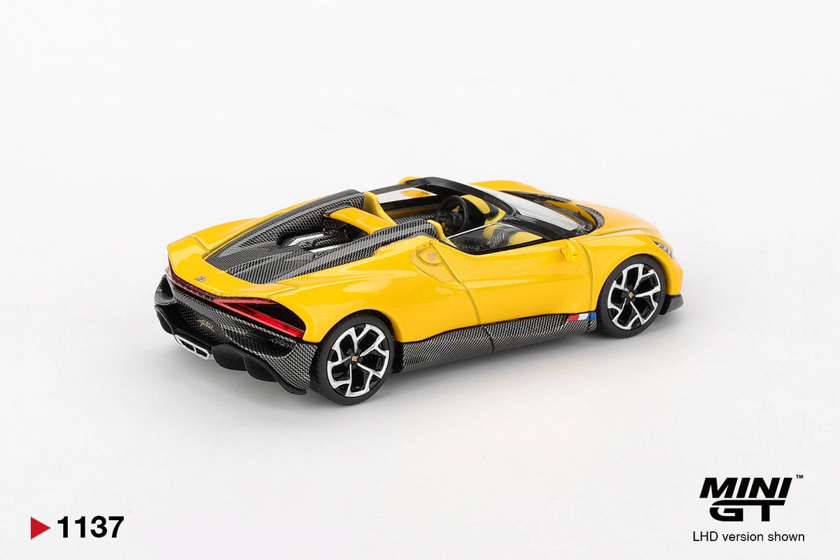 Rear three quarter view of Mini GT Bugatti W16 Mistral Yellow LHD showing the red rear light strip, black diffuser, yellow bodywork and open cockpit