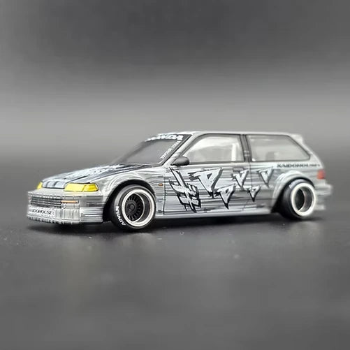 Mini GT Honda Civic EF Kaido Manga V1 front three-quarter view showing yellow headlights, alloy wheels and manga graphics