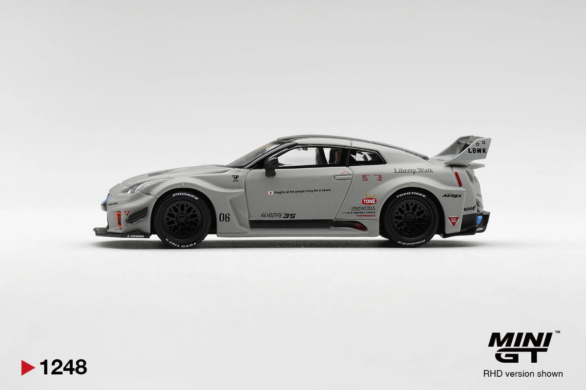 Side profile of Mini GT Nissan LB-Silhouette WORKS GT 35GT-RR Matt Grey RHD showing Liberty Walk graphics, race number 06, black multi-spoke wheels, widened wheel arches and large rear wing.