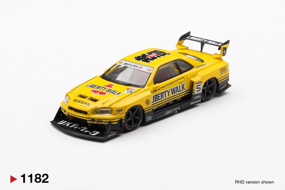 Front three-quarter view of Mini GT Nissan LB-ER34 Super Silhouette Skyline Sport Yellow RHD showing the extended black front splitter, Nissan bonnet branding, Liberty Walk graphics, race number 5 and large rear wing.