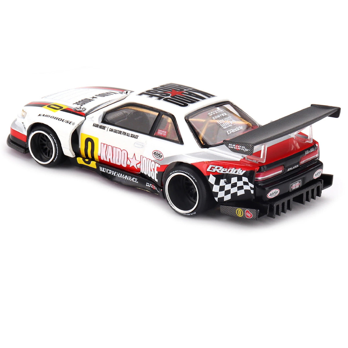 Mini GT Nissan Silvia S13-R Circuit Spec V1 rear three-quarter view showing the large rear wing, diffuser and racing graphics