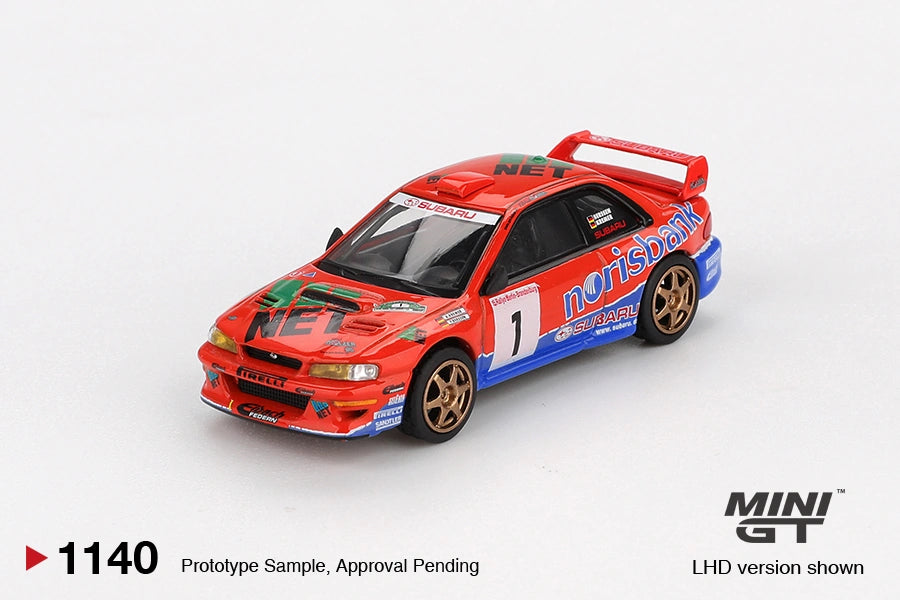 Front three quarter view of Mini GT Subaru Impreza WRC97 No.1 1999 DRM Champion LHD showing the orange bonnet with NET graphics, front grille, race number 1 and gold wheels